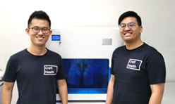 Two men standing in front of a television

Description automatically generated with low confidence