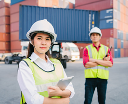 A person in a safety vest and a person in a hard hat

Description automatically generated