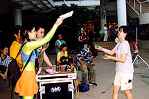 Vivien giving free tickets to Sentosa Island to Lillian at the 3 ball endurance